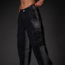 Black cargo pants worn by a person on a dark background