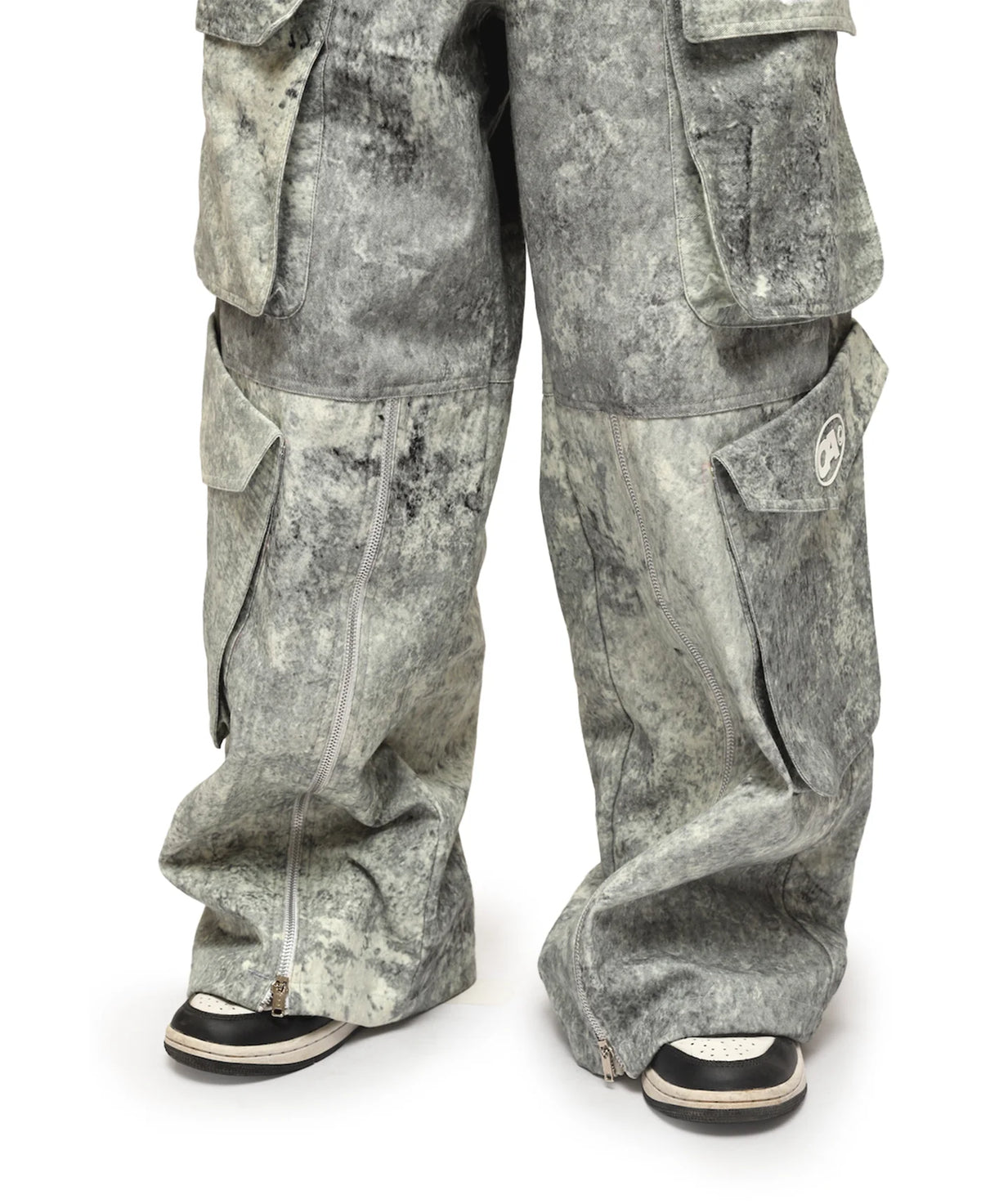 Ash-gray cargo pants with stitched panels and flap cargo pockets on the thighs.