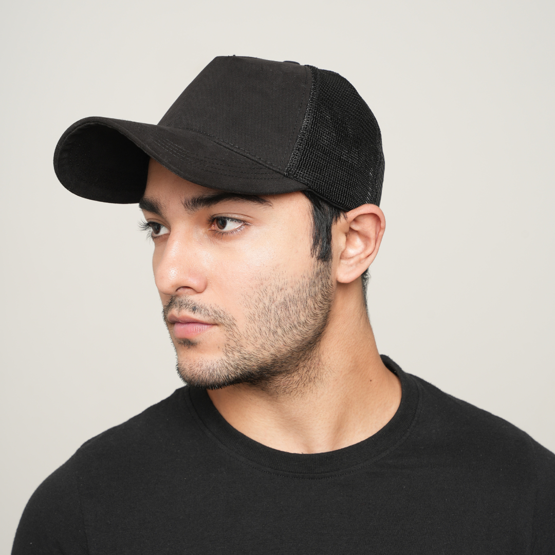Black baseball cap with mesh back and curved brim, side view