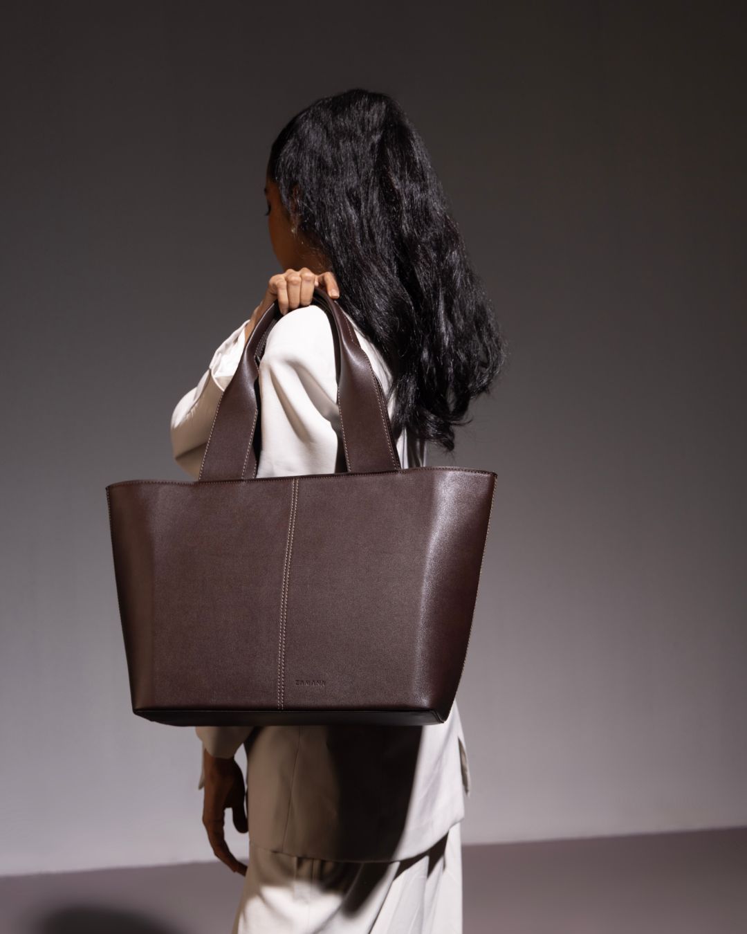 Dark brown structured tote bag with double top handles and open top