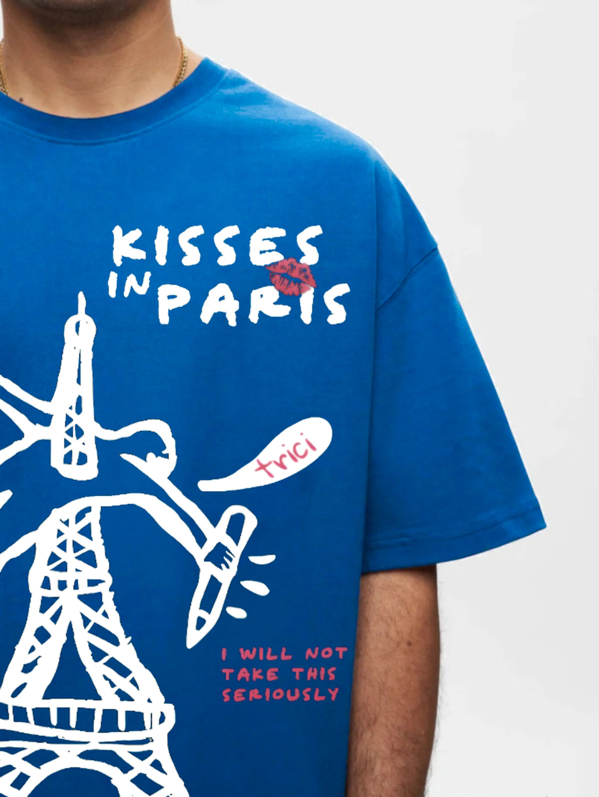 Blue T-shirt showing 'KISSES IN PARIS' lettering and Eiffel Tower graphic