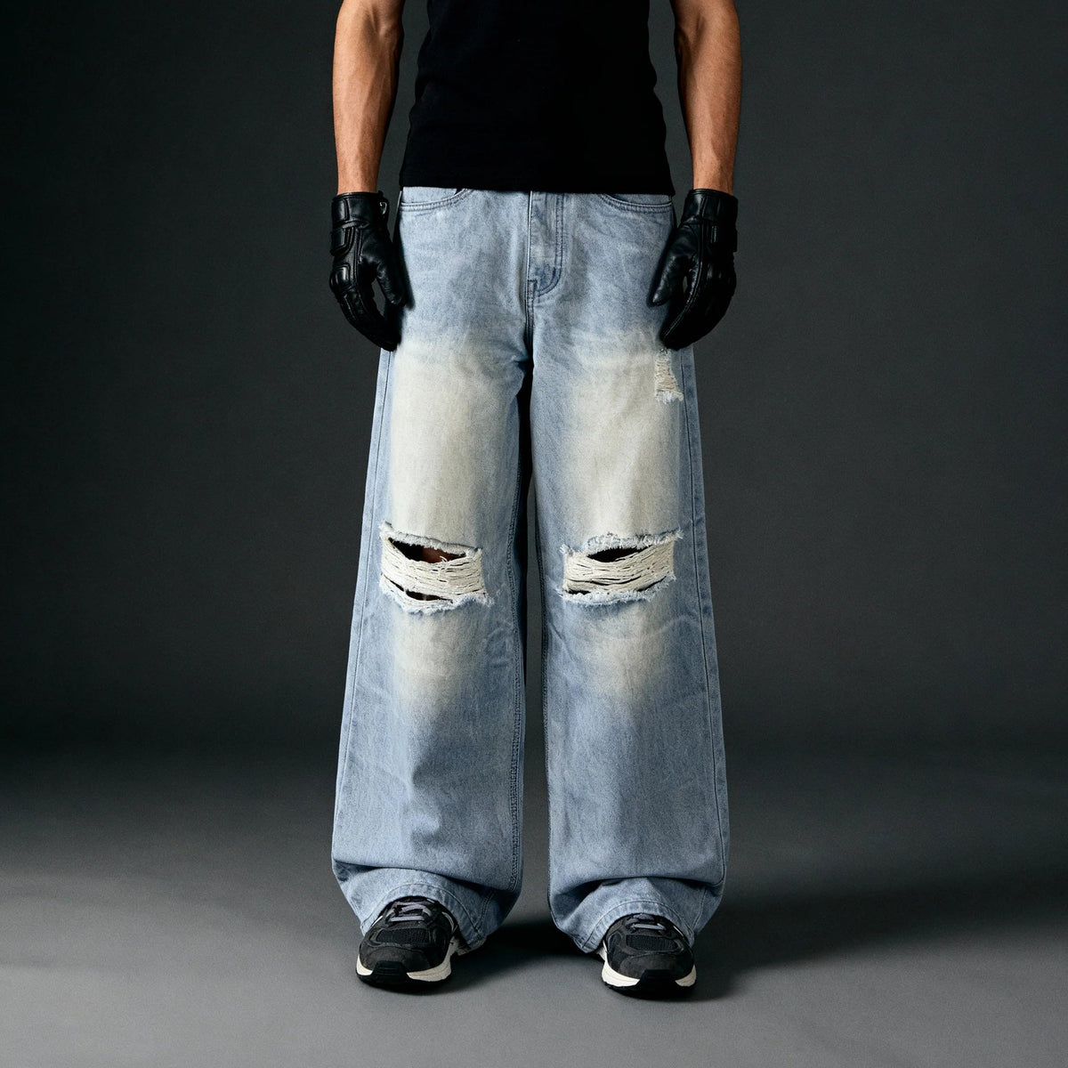 Light blue baggy jeans with knee rips, loose wide-leg fit, five-pocket design.