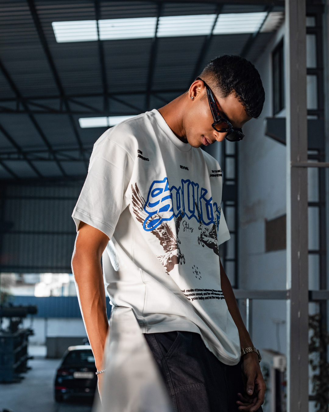 White crewneck short-sleeve graphic tee, blue and dark print on front