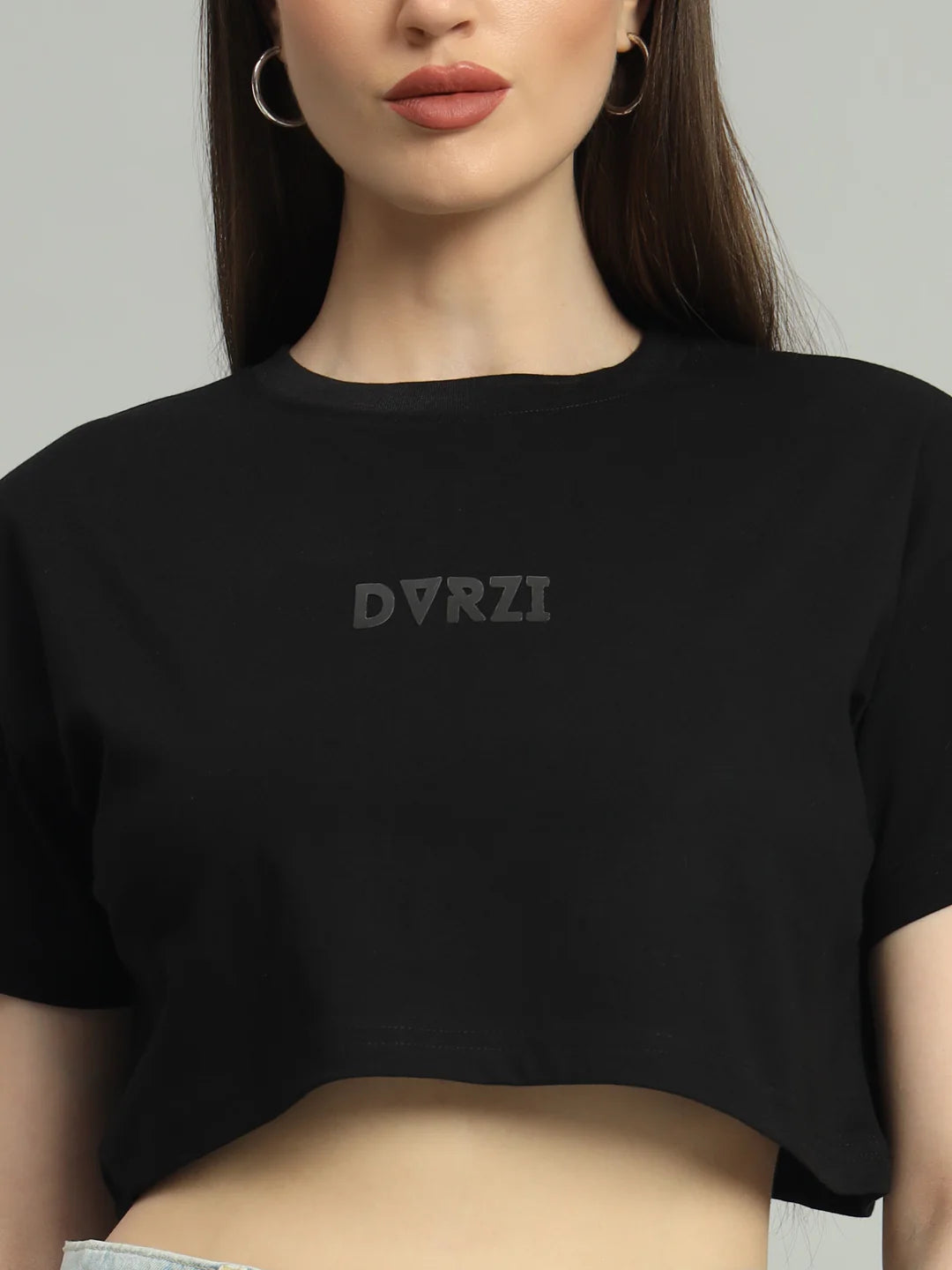 Black cropped T-shirt close-up with DVRZI logo on front