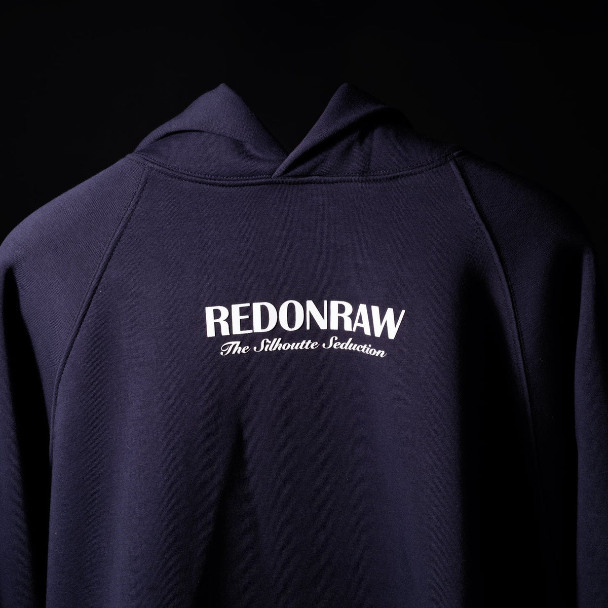 Dark navy hoodie front view with REDONRAW logo and slogan text on chest