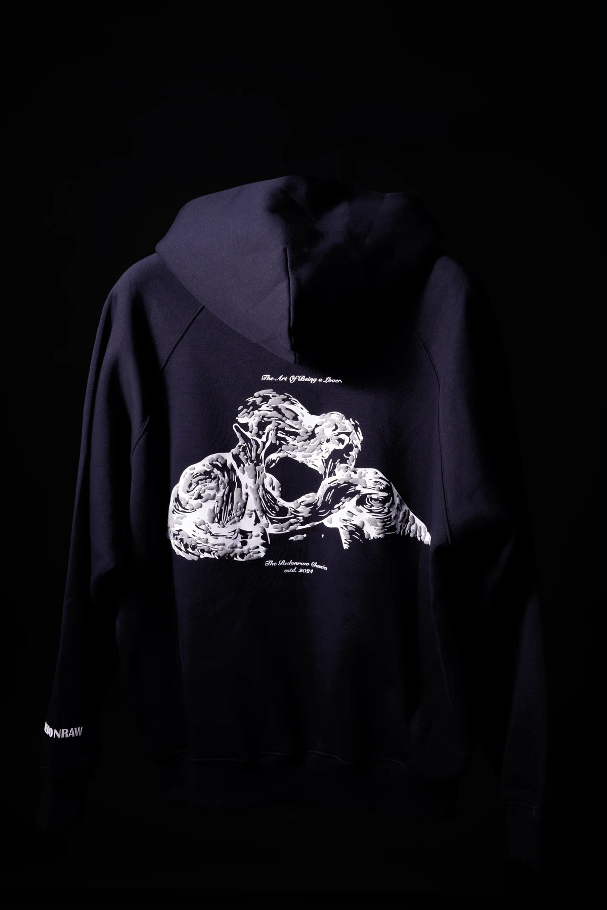 Dark navy hoodie back view with white graphic print under the hood