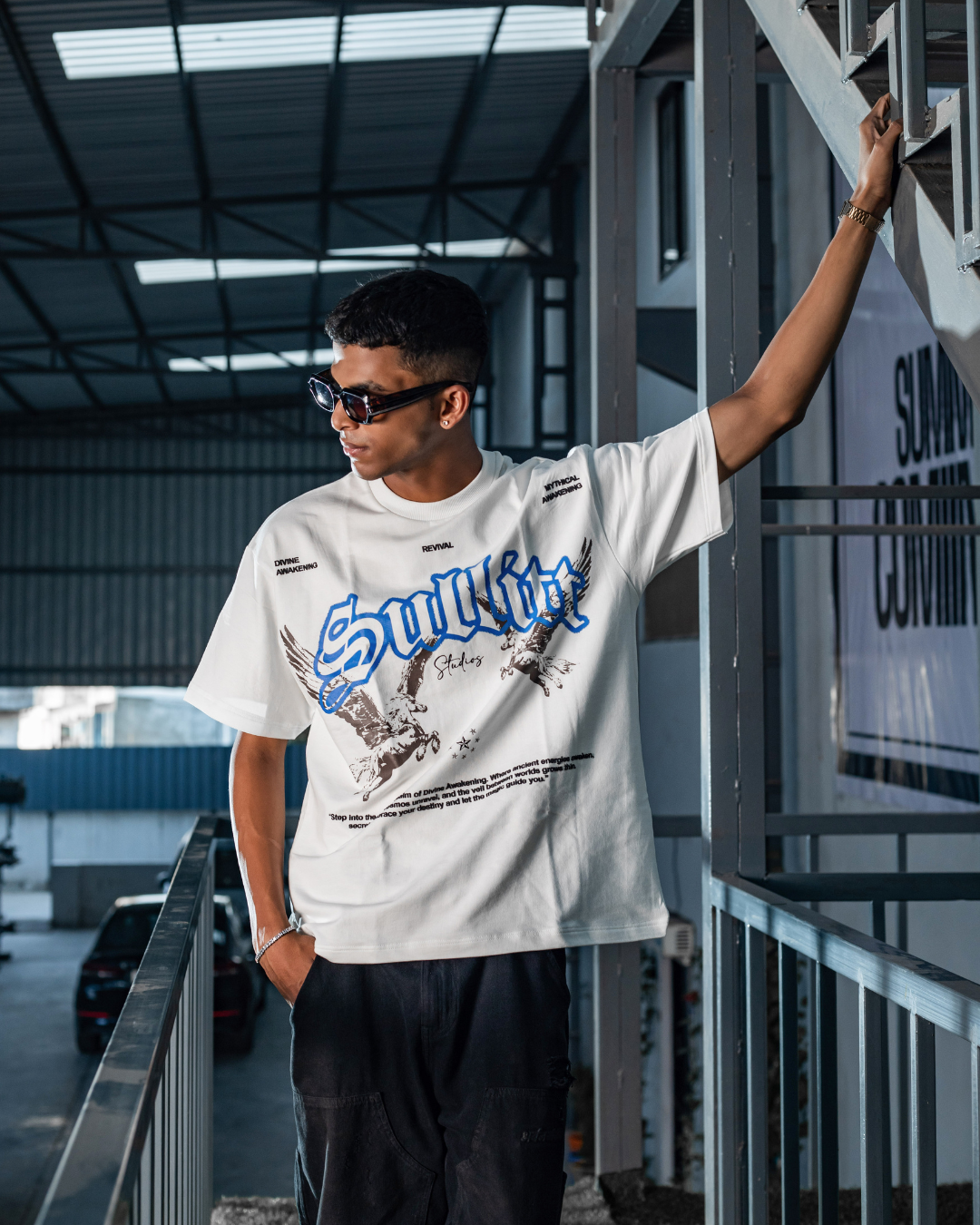 White crewneck short-sleeve graphic tee with blue lettering and illustration on front