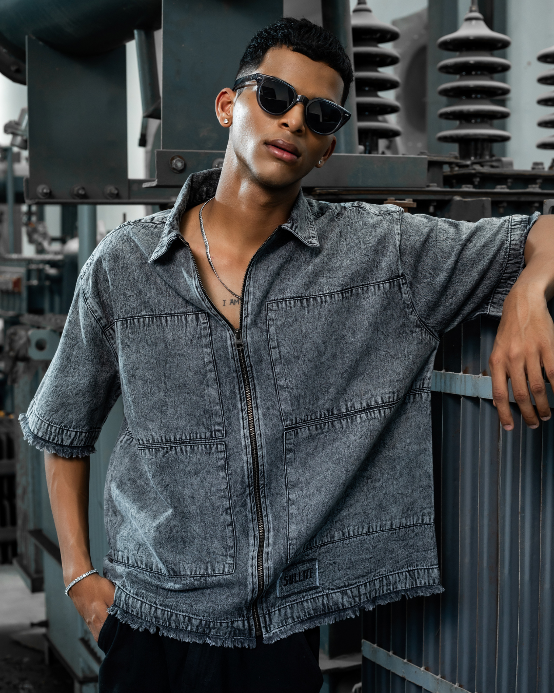 Washed denim zip-front jacket with chest pocket, short sleeves, and frayed hem