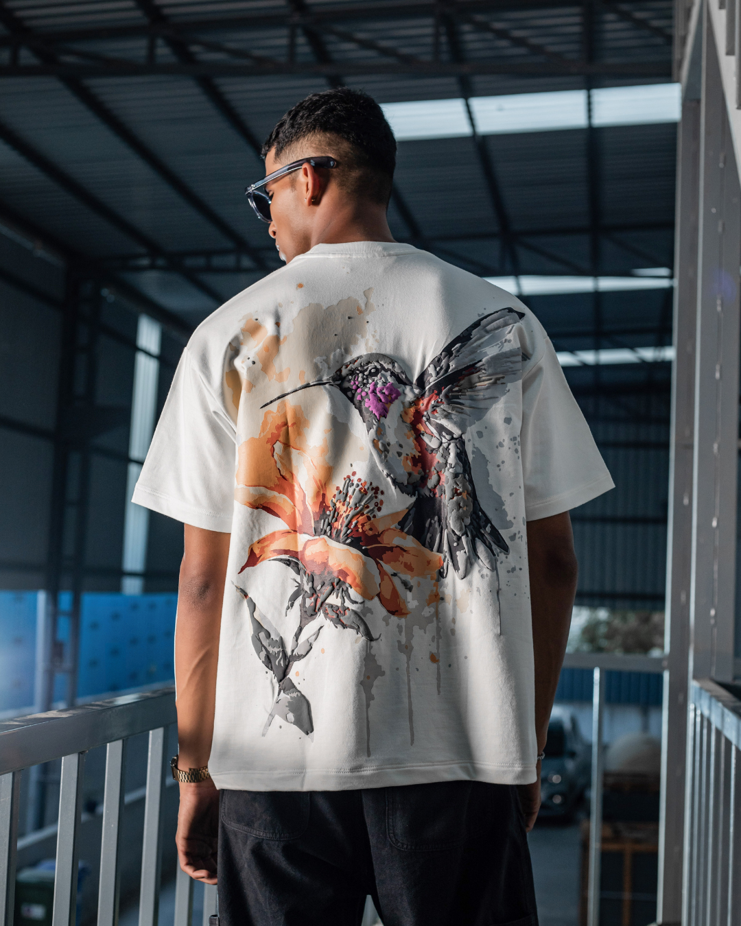 White crewneck graphic T-shirt with large multicolor splatter graphic on back