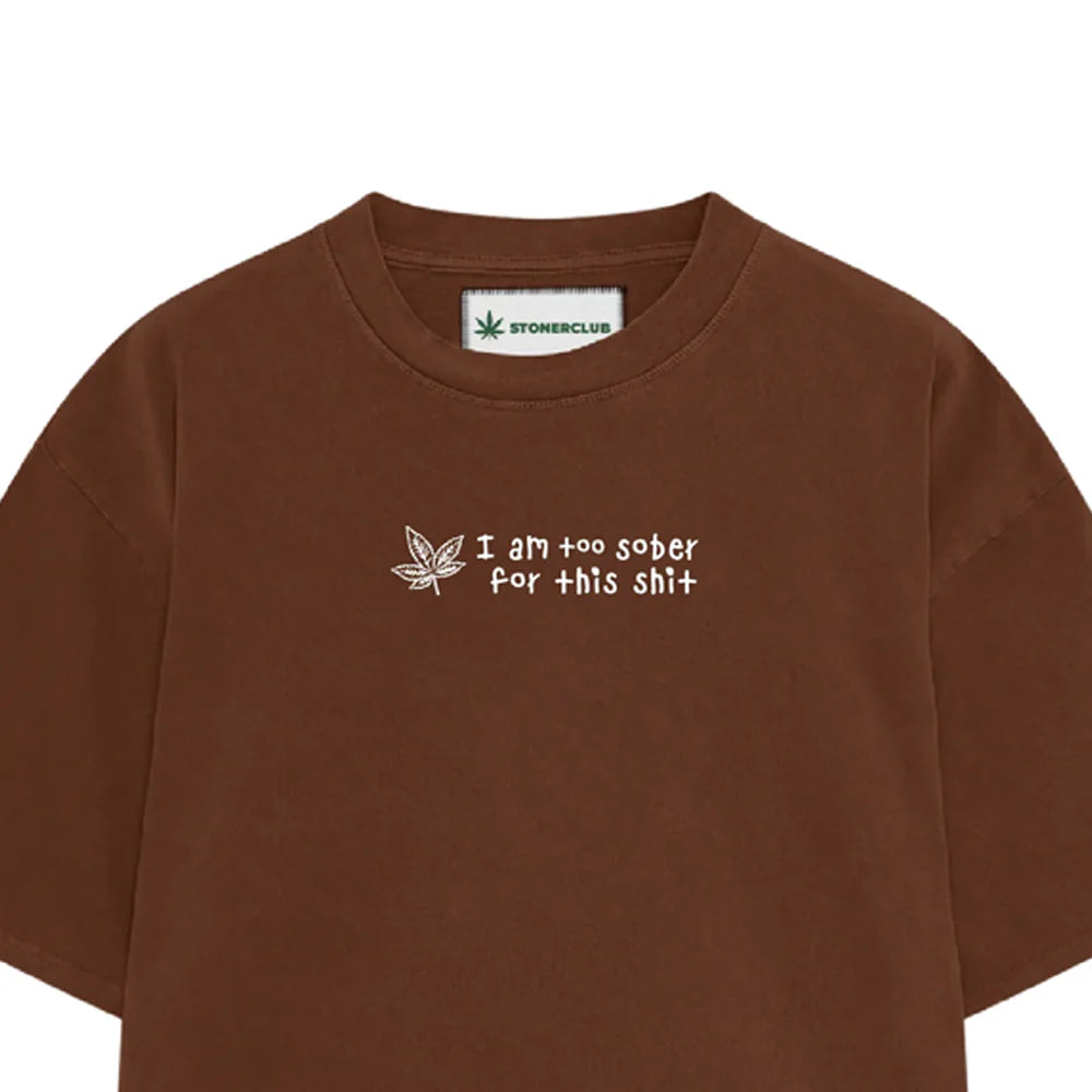 Brown short-sleeve T-shirt with front marijuana-leaf logo and slogan print