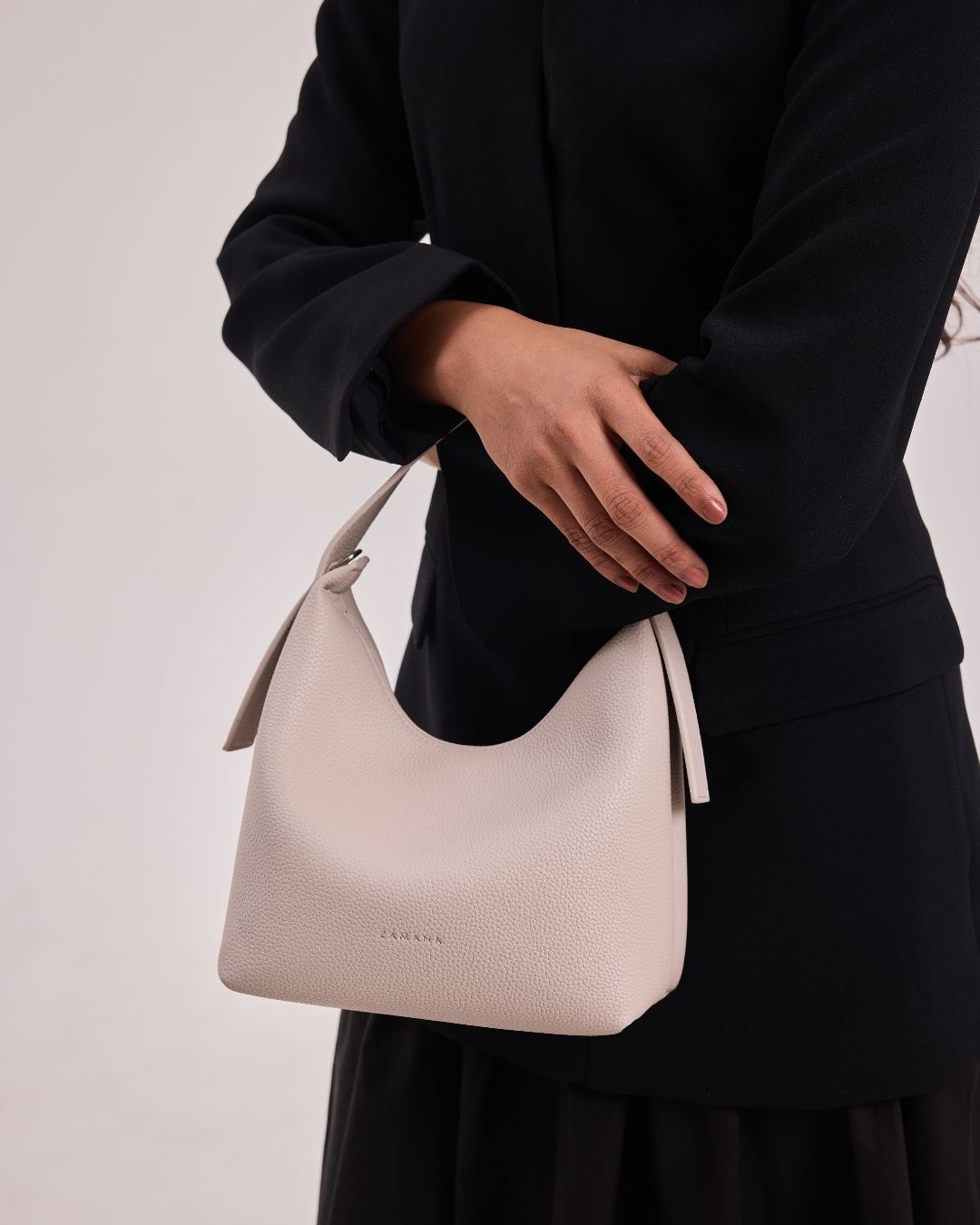 Cream fabric hobo bag with short handles and tied top closure