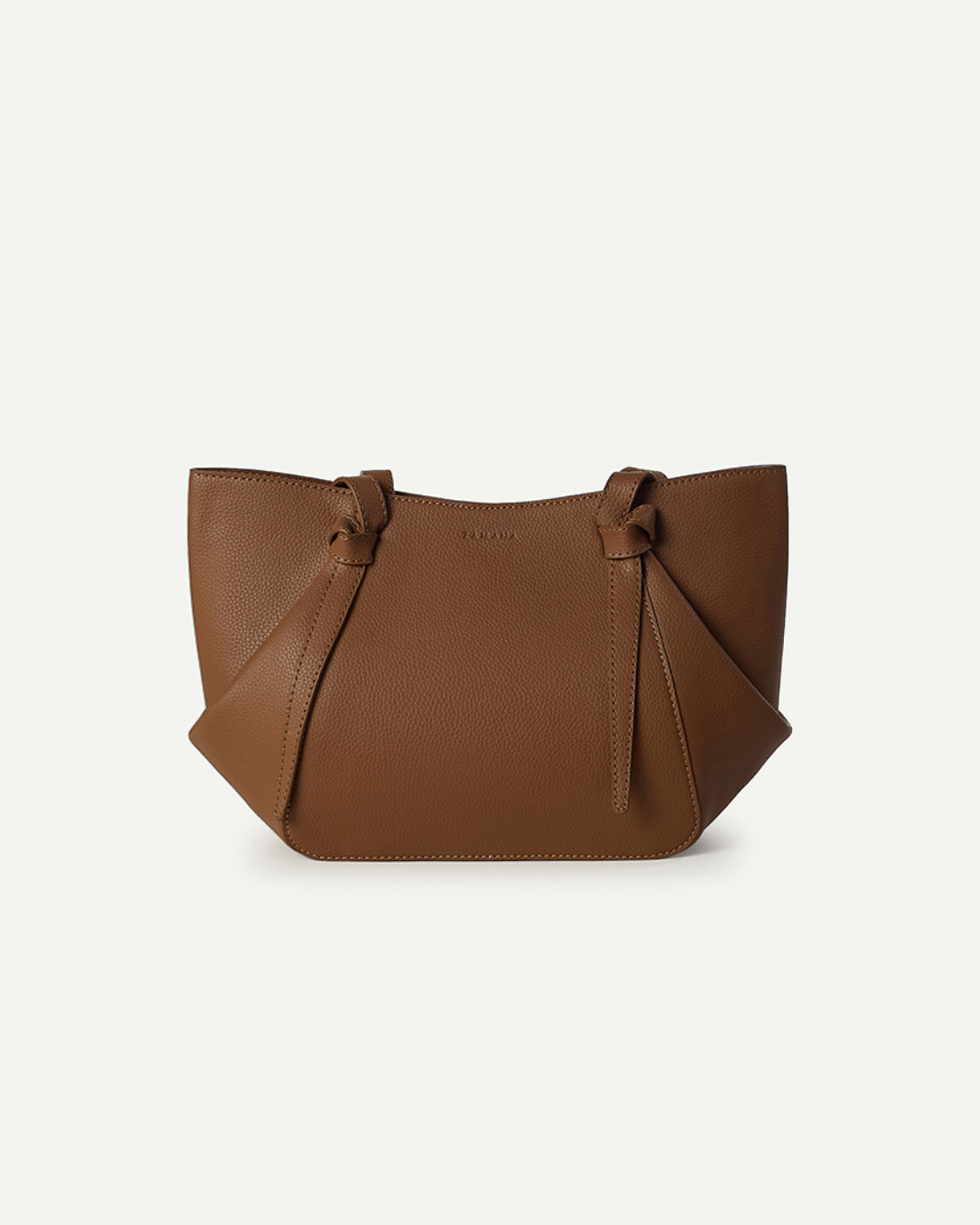 Tan leather drawstring top mini bag with knot closures and dangling tassels