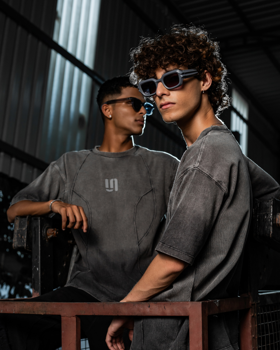 Grey threadbare crew-neck t-shirt with short sleeves and chest logo, front/side