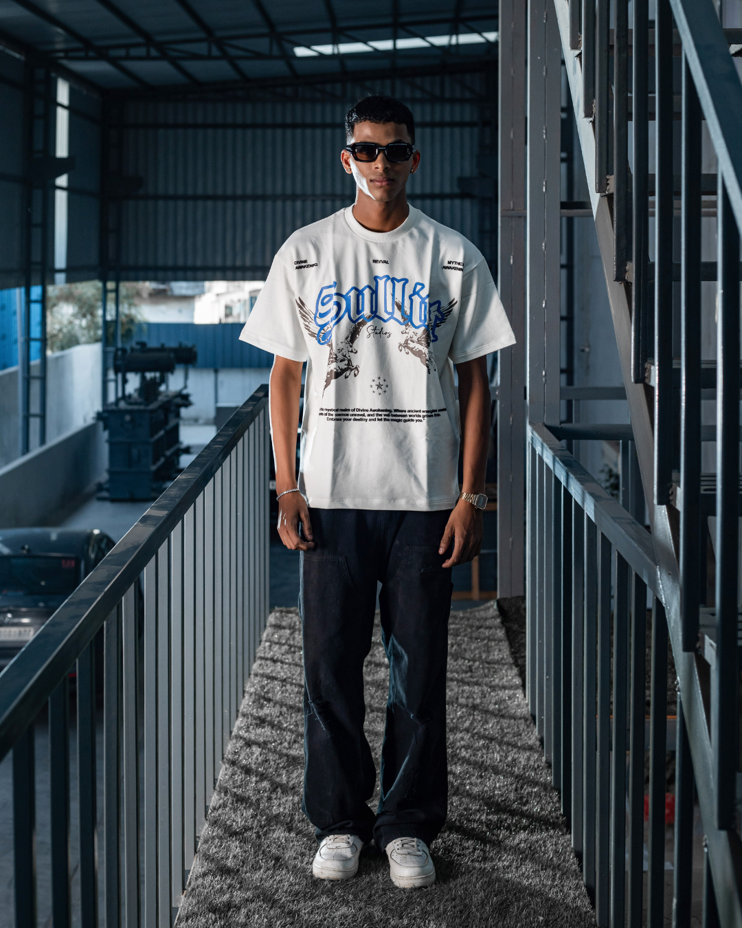 White crewneck short-sleeve graphic tee, blue logo and bird graphic on front