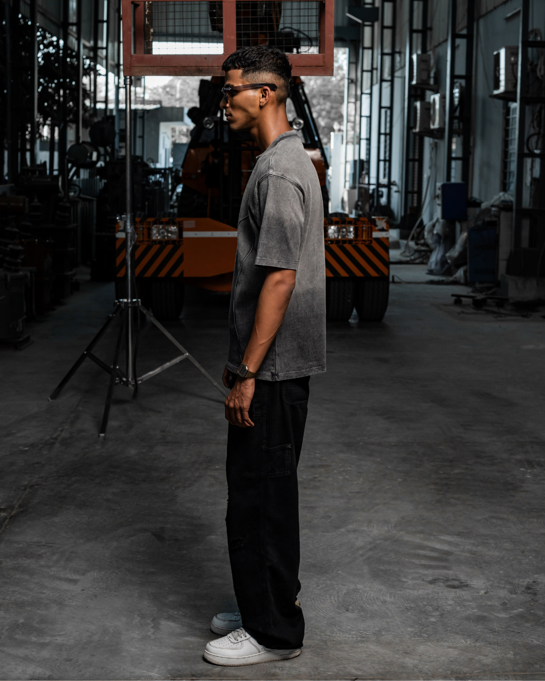 Threadbare grey crew-neck t-shirt with short sleeves, worn in profile