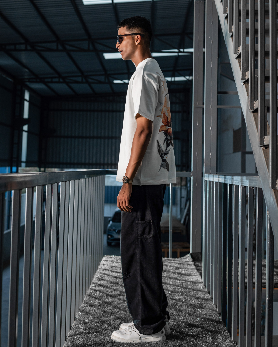 White crewneck graphic T-shirt with small front SunZeta logo, side view