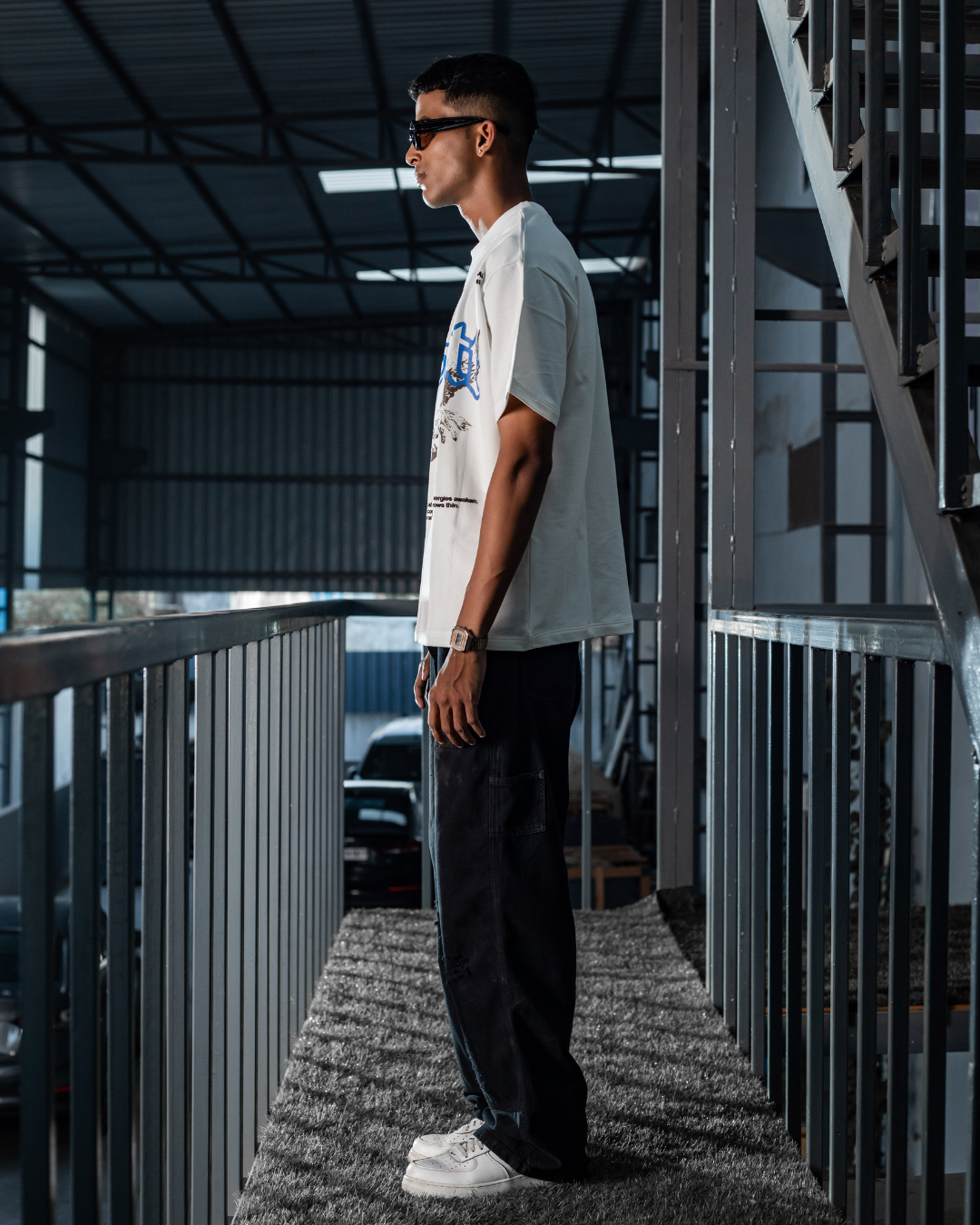 White crewneck short-sleeve graphic tee, side view showing front print and hem