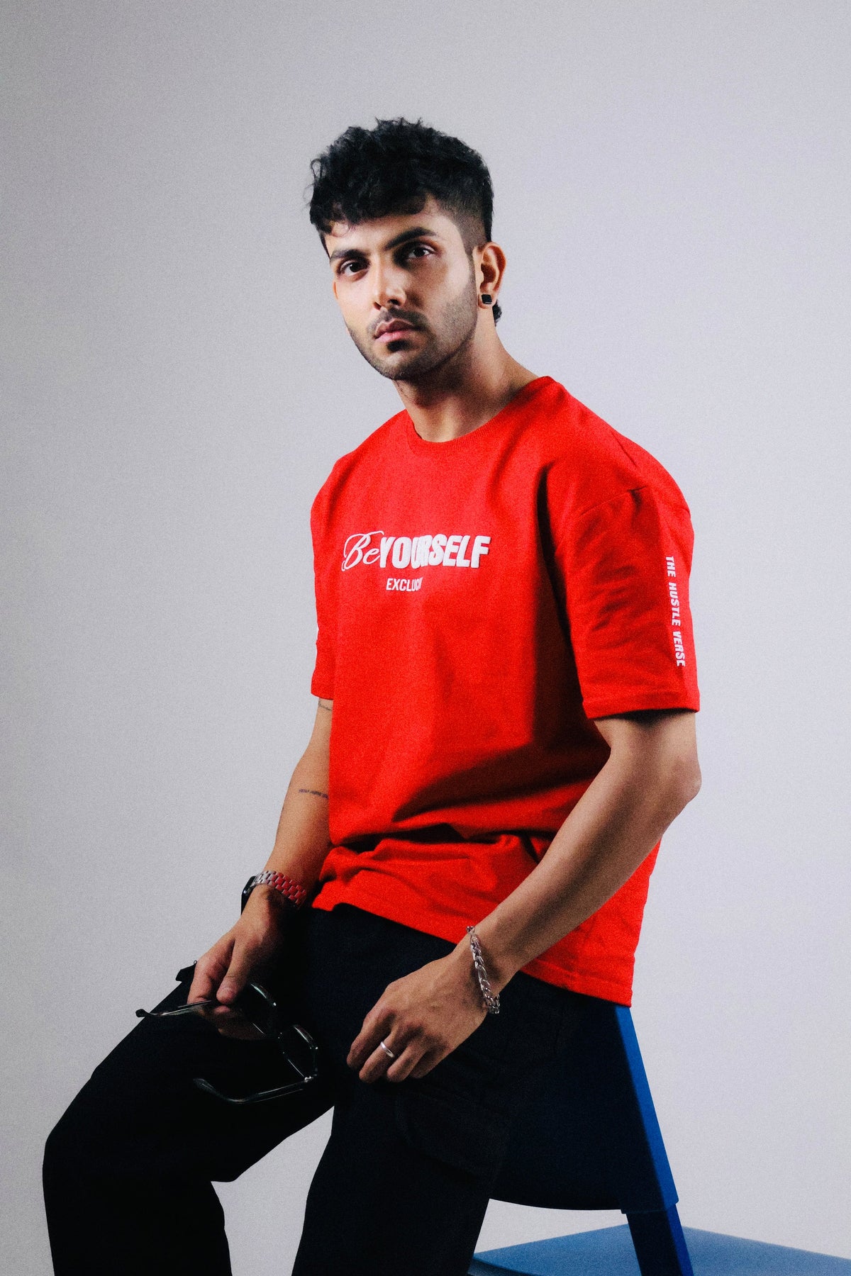 Red oversized T-shirt with front Be Yourself script logo.