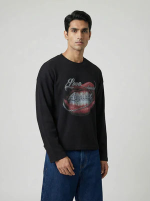 Black crewneck long-sleeve sweatshirt with red lips graphic, model wearing blue jeans