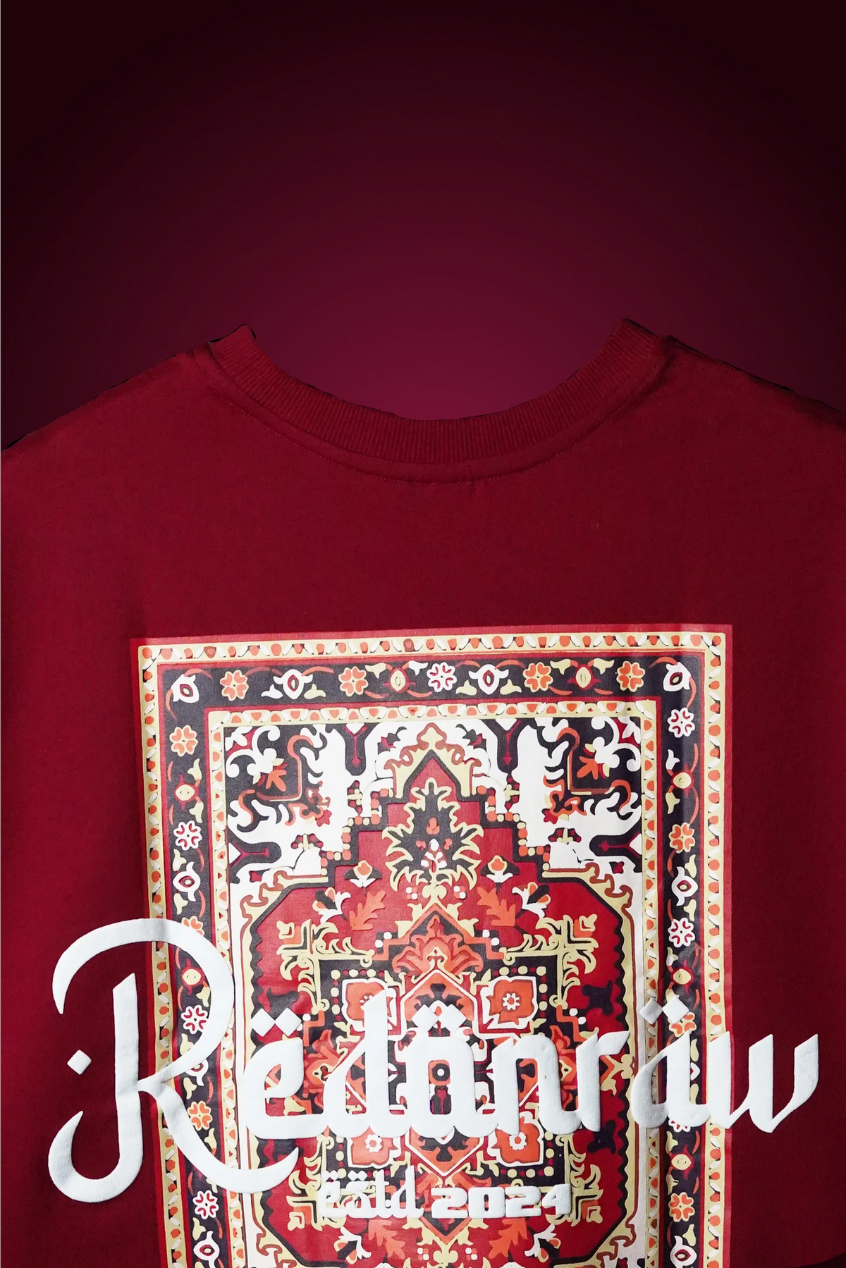 Crimson red T-shirt with front ornate square Arabic graphic and white lettering