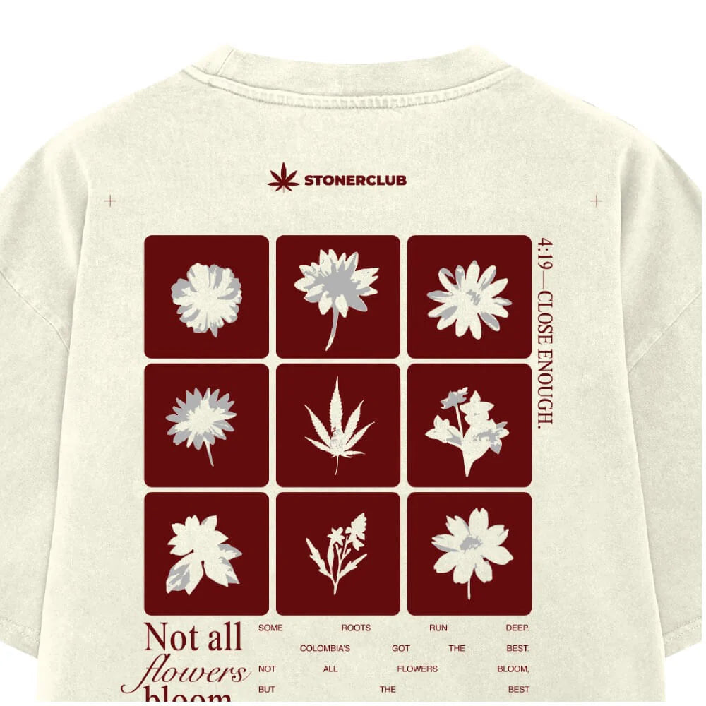 Off-white T-shirt with back floral panel of white blossoms and 'Not all flowers bloom.'