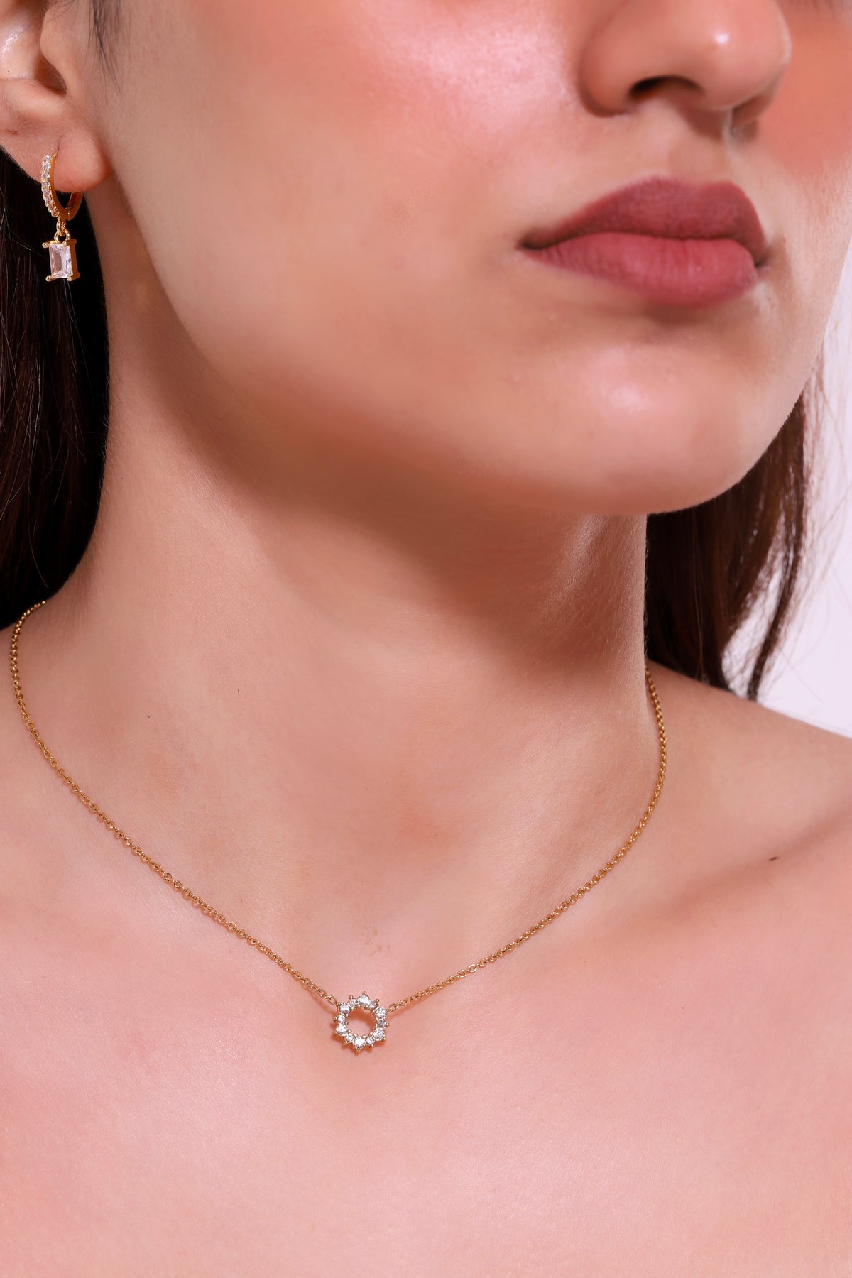 Gold chain necklace with round halo pendant and small clear stones