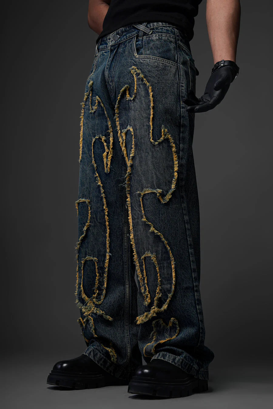 Blue denim jeans with large gold embroidered distress, straight leg, button fly.