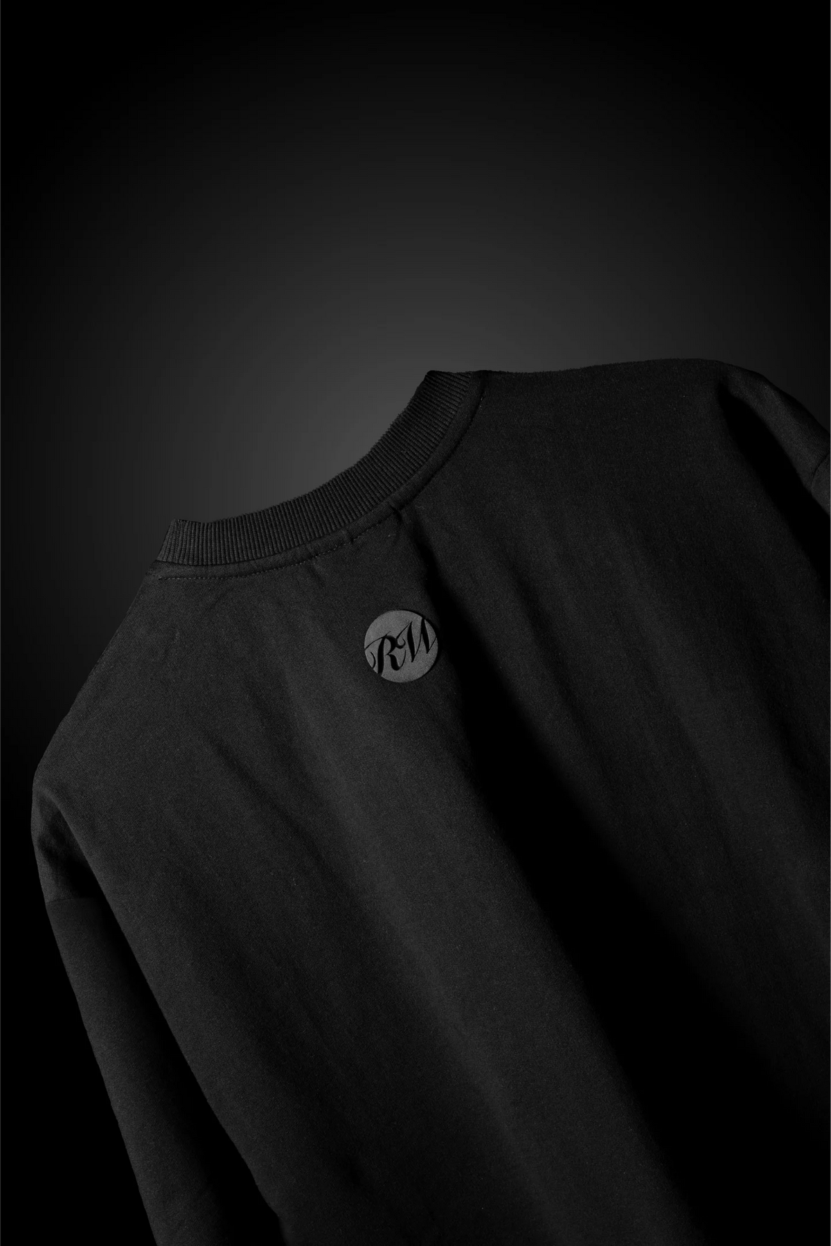 Black crewneck T-shirt with circular chest logo