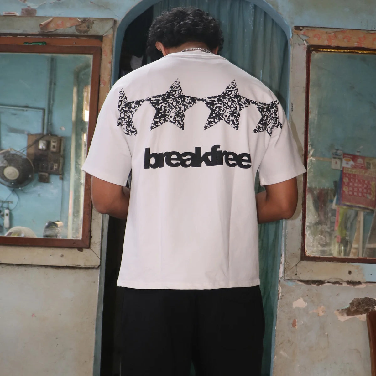 White T-shirt with back 'breakfree' text and repeating black pattern across shoulders