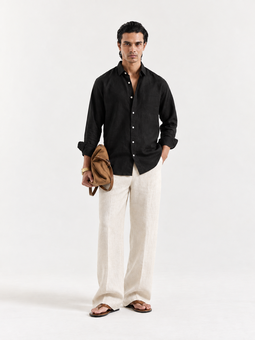 Black linen button-up shirt with collar and long sleeves, worn open over chest.