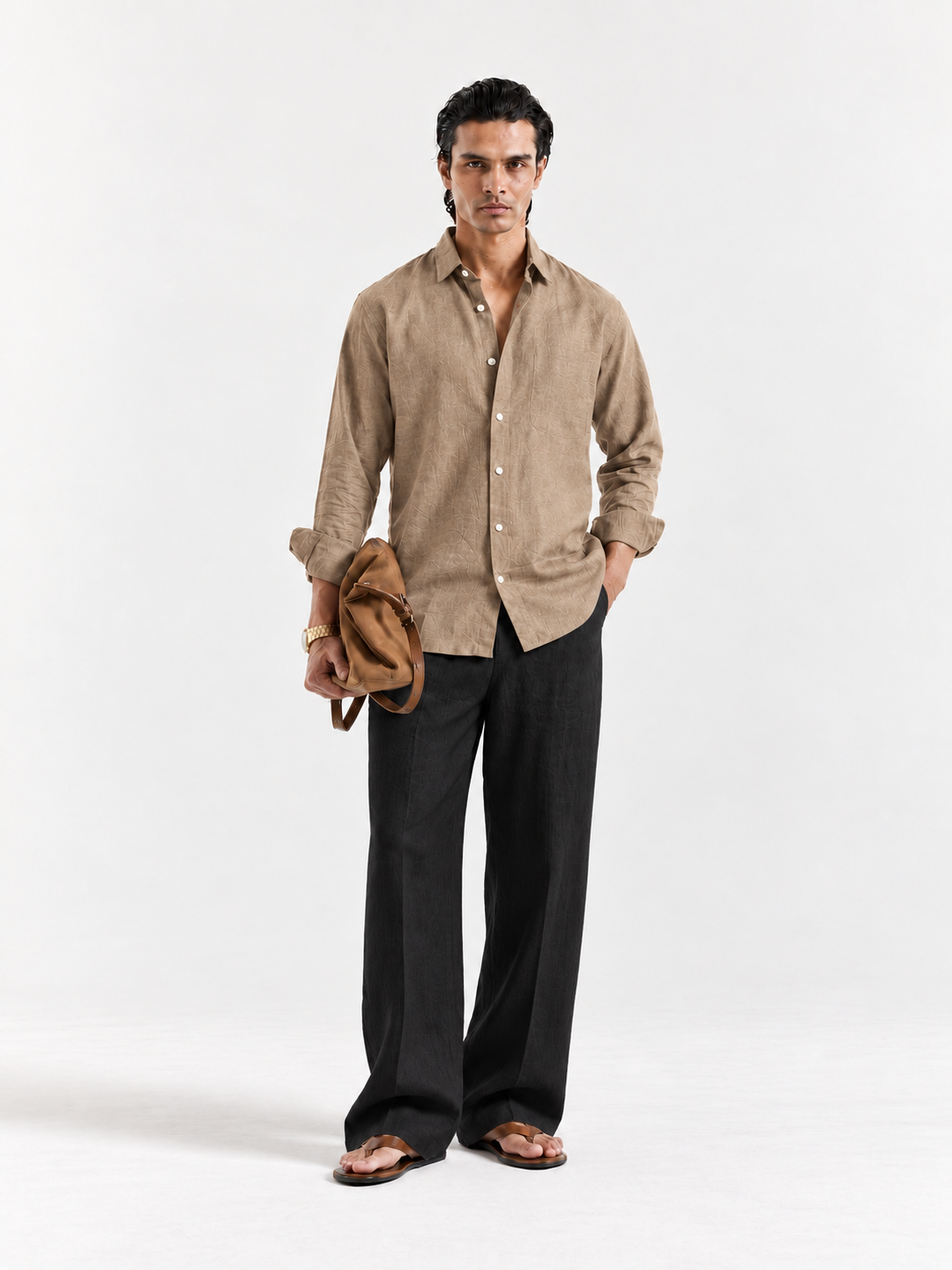Tan linen button-up shirt with point collar and long sleeves, worn with black trousers