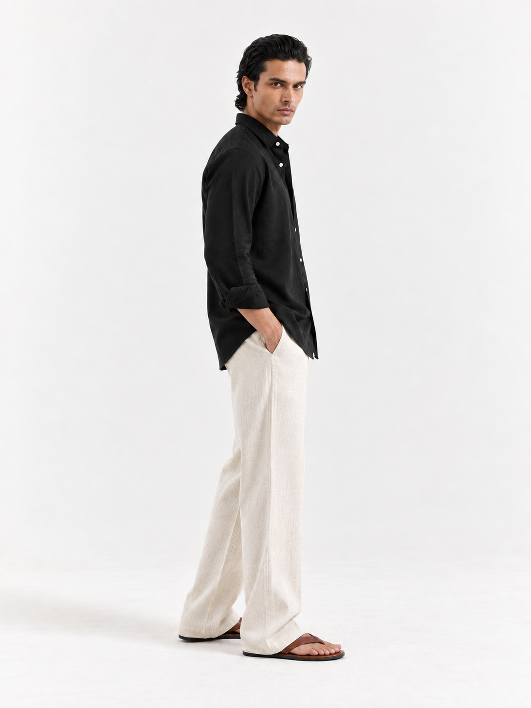 Black linen button-up shirt with collar, long sleeves, and white button front.