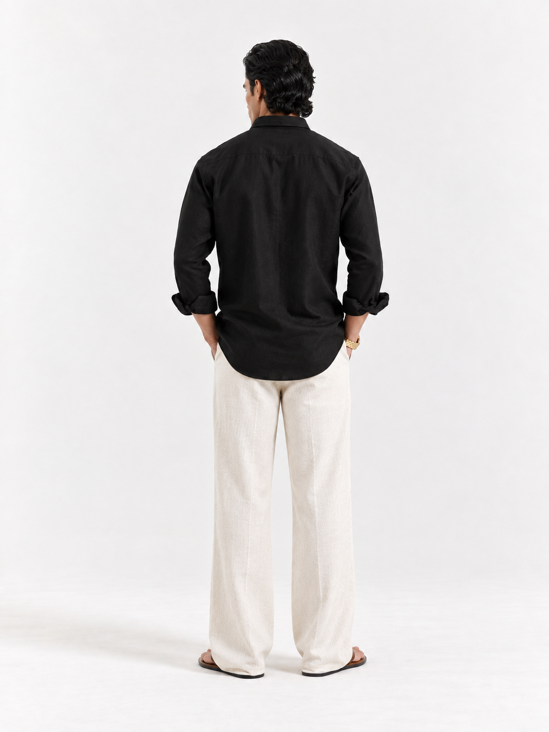 Black linen button-up shirt, back view with long sleeves and button placket.