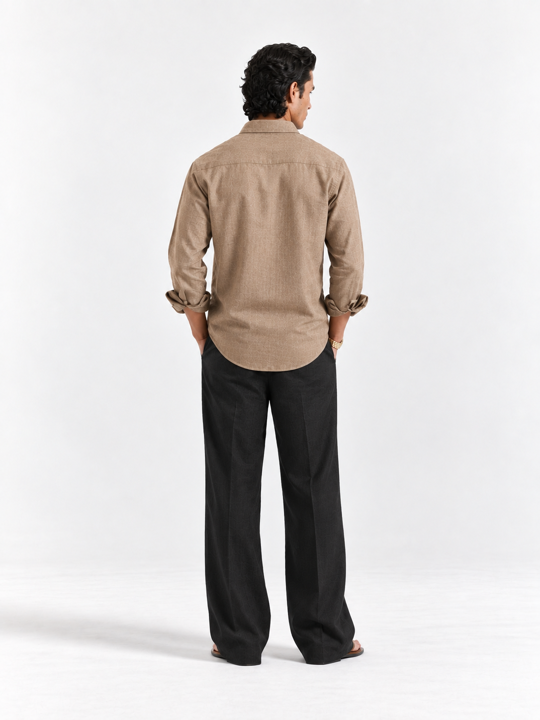 Tan linen button-up shirt from back with full-length sleeves and yoke
