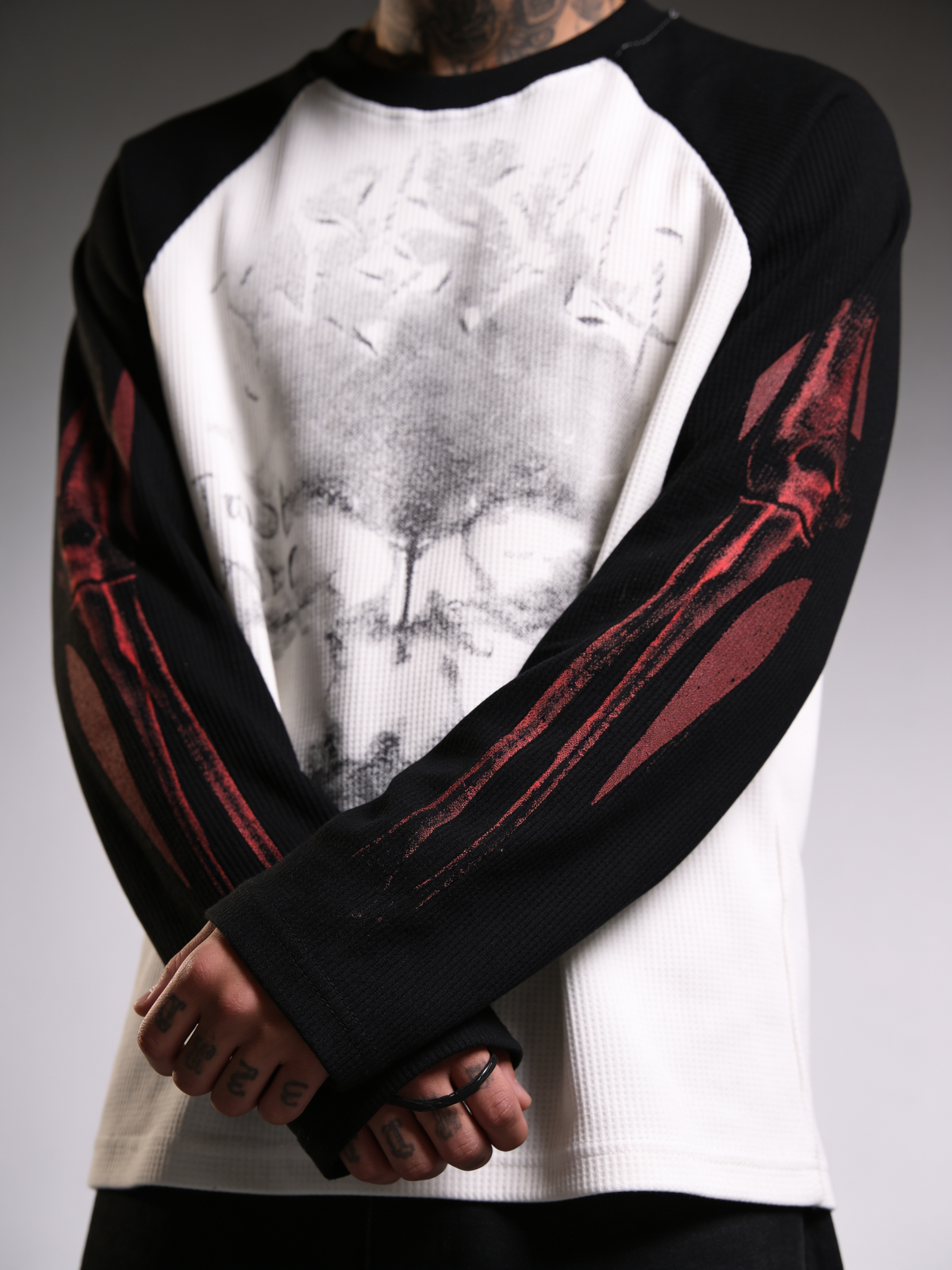 Black waffle raglan sleeve top with white body and large distressed front print.