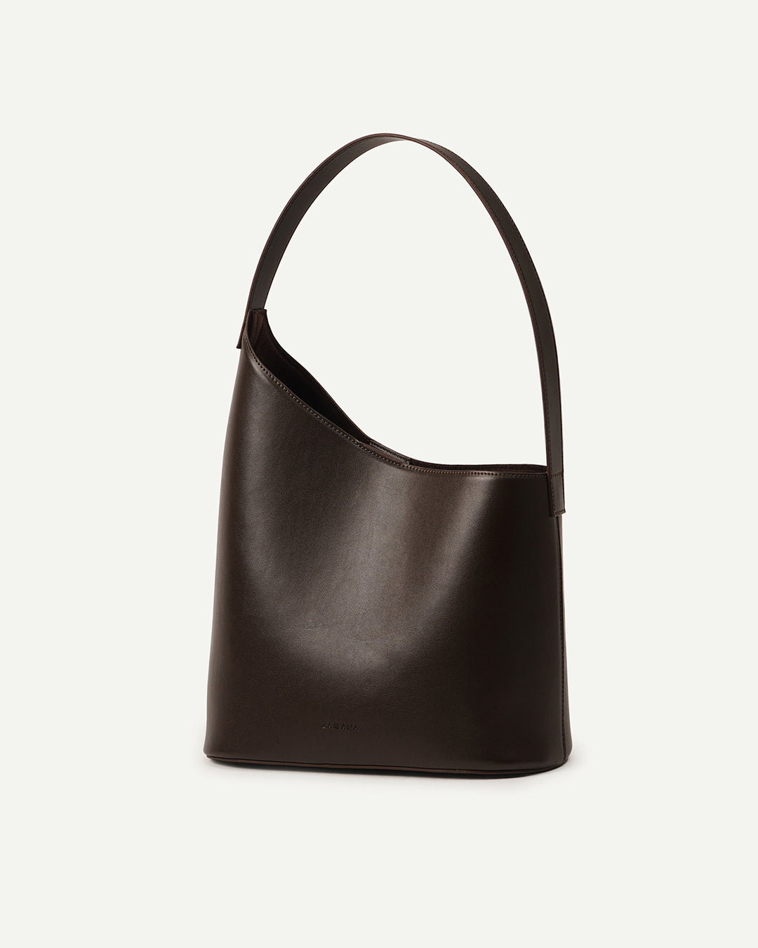 THE DECEMBER dark brown leather shoulder bag side profile with curved handle