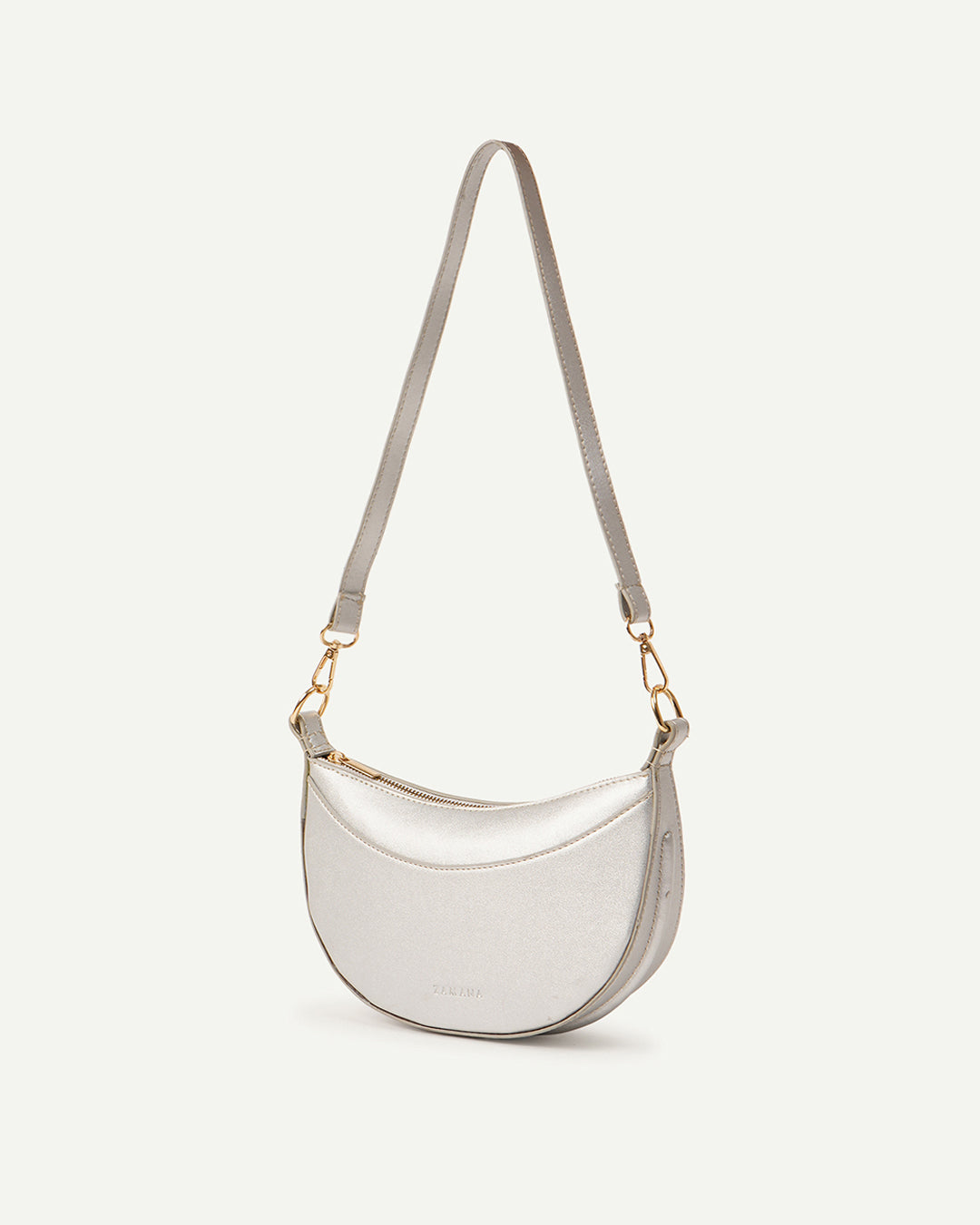 Silver crescent shoulder bag with adjustable straps and curved front panel