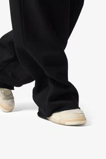 Black baggy sweatpants, wide legs with gathered cuffs and side seam