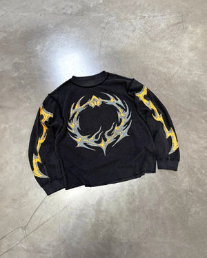 Black flame knit long-sleeve top with yellow and blue flame swirl graphic