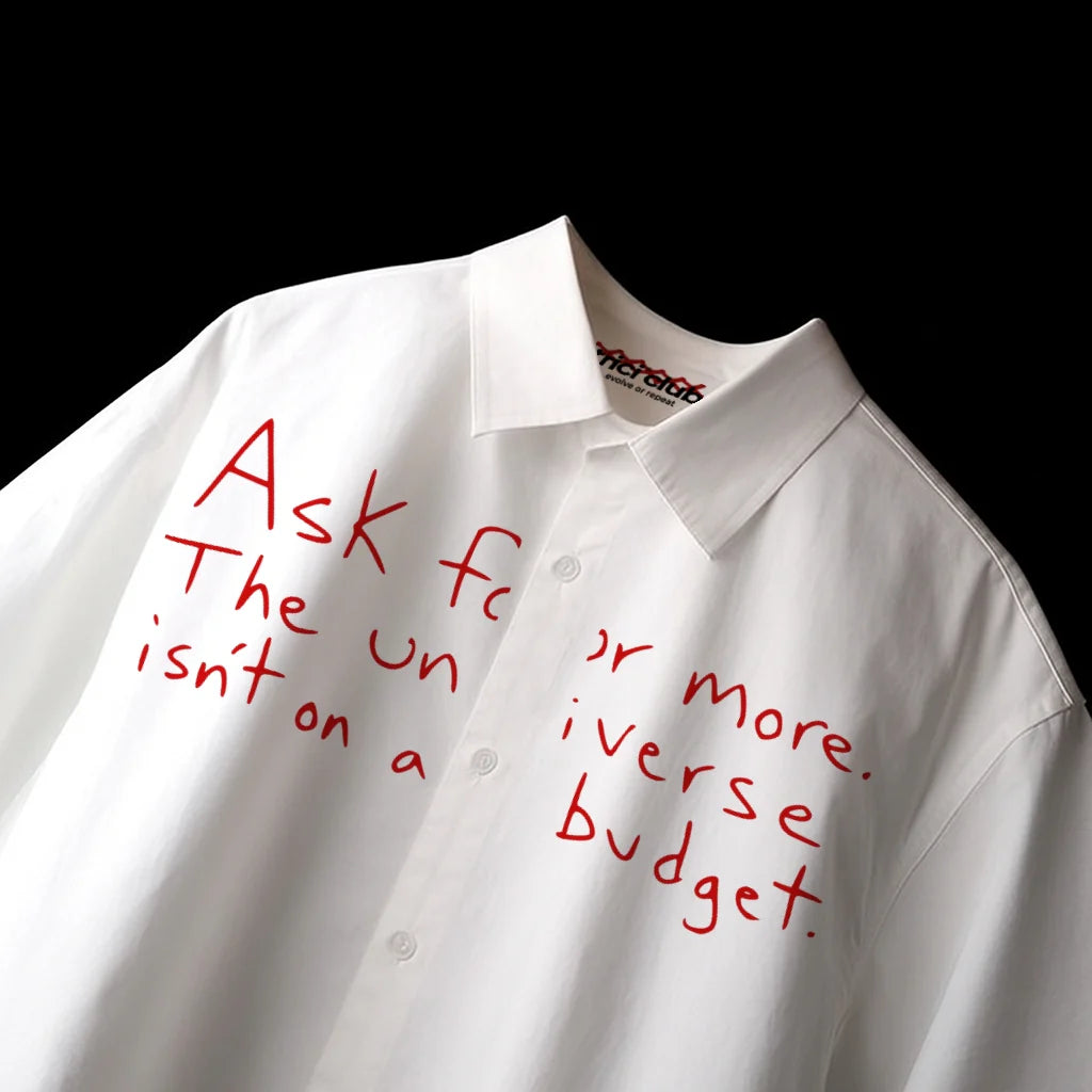White boxy-fit button-up shirt with red front text graphic, angled view