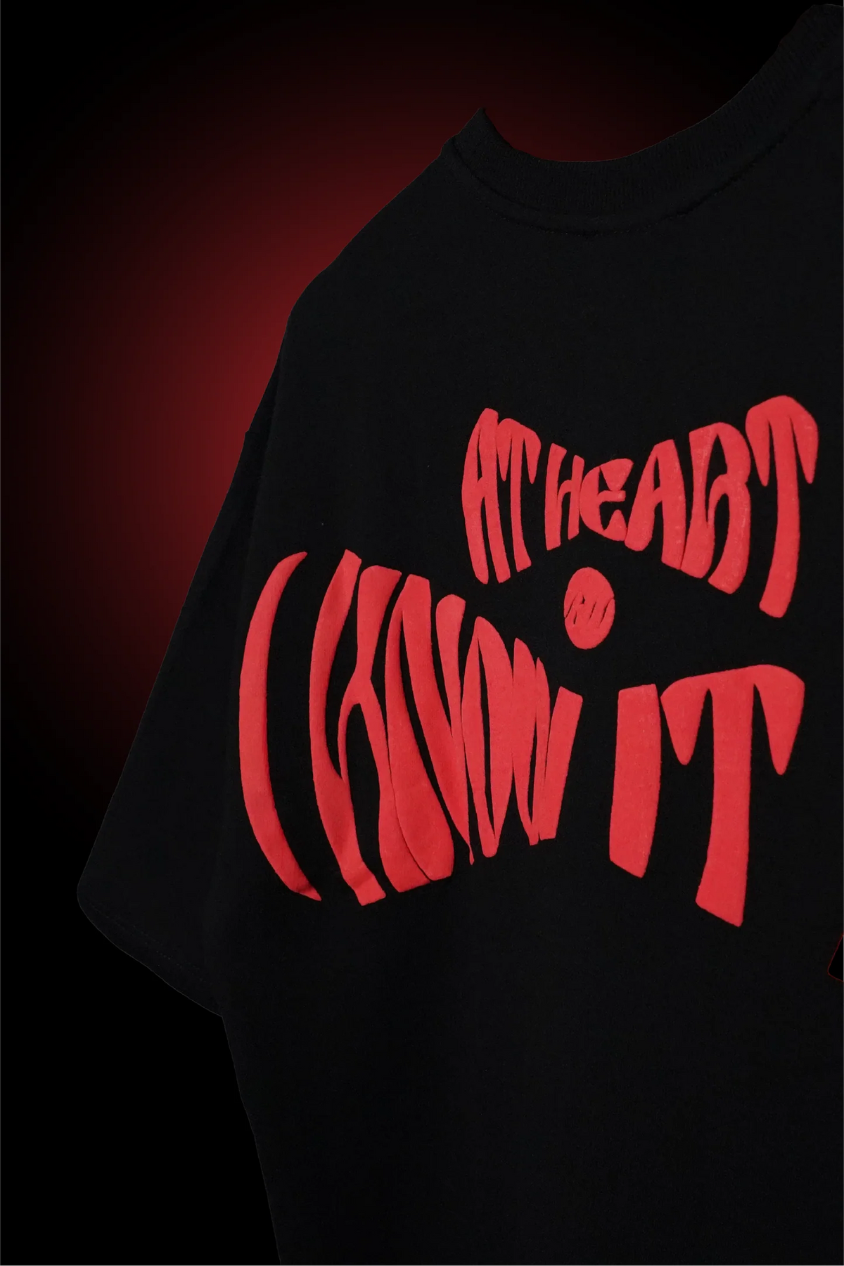 Black crewneck T-shirt with red typographic front graphic and short sleeves.