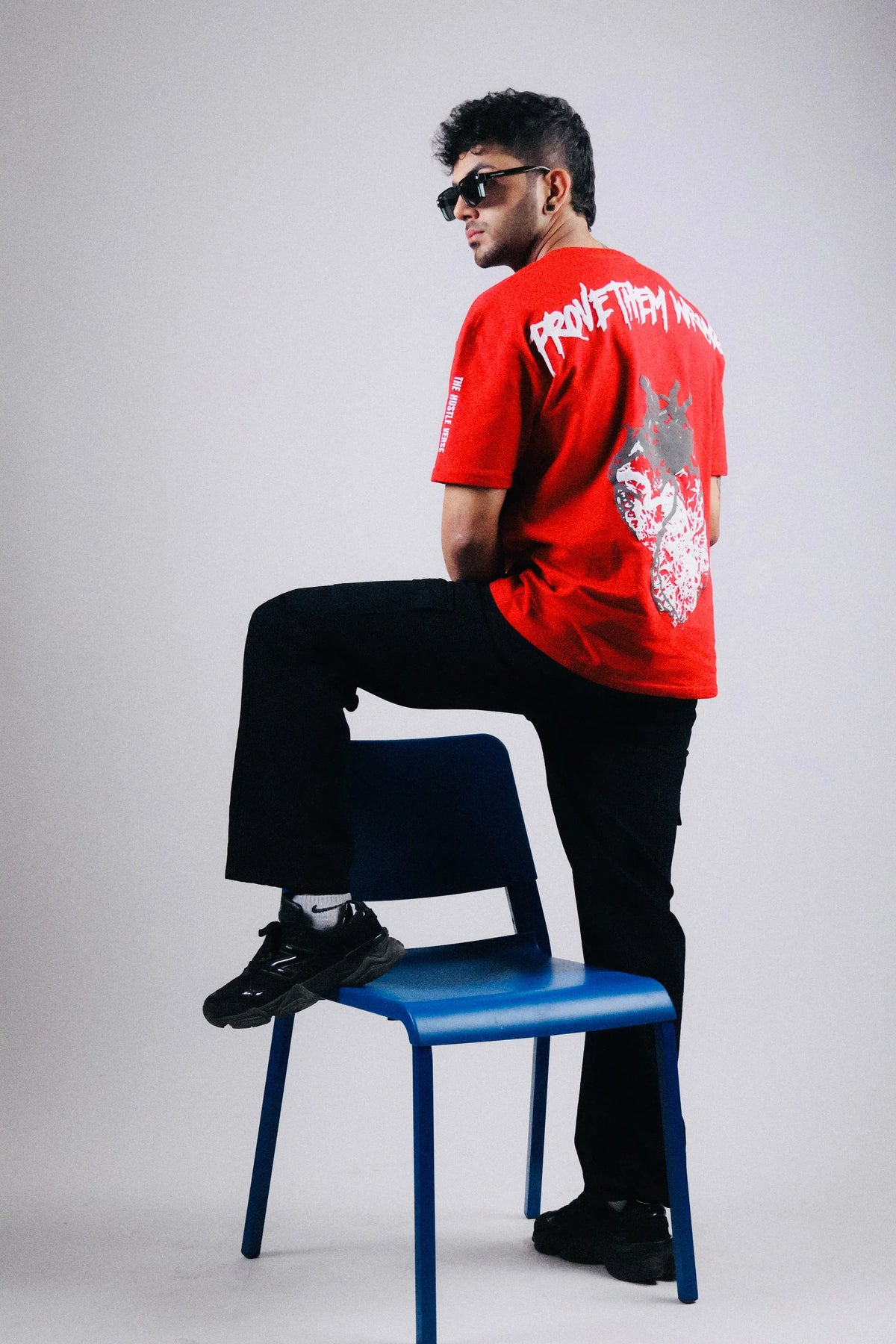 Red oversized T-shirt with side view; back text and distressed graphic.