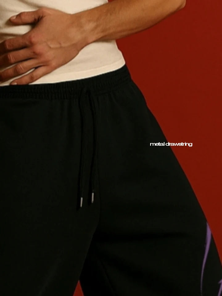 Black sweatpants waistband close-up with drawstring and ribbed hem