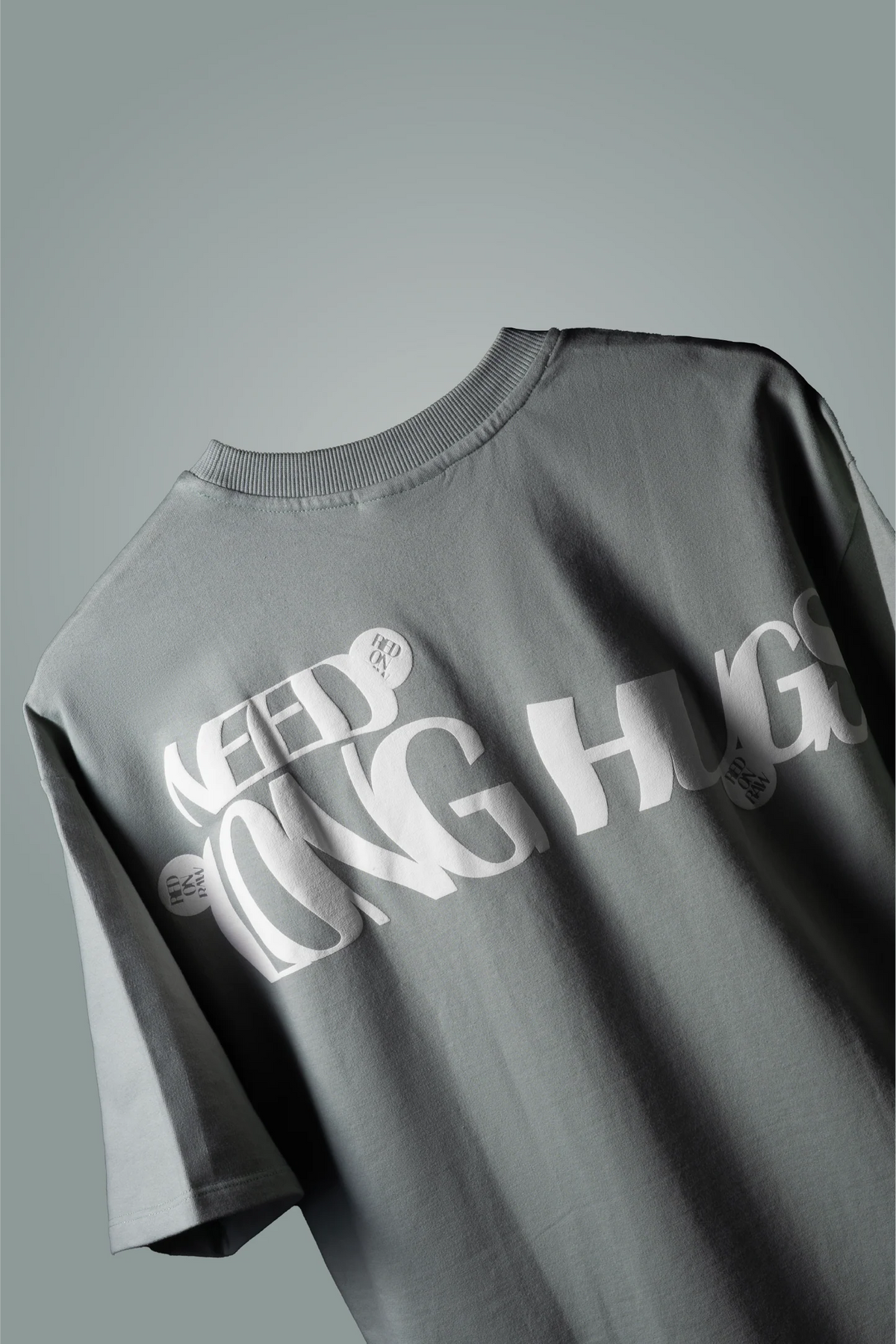 Mint green crew-neck T-shirt with 'FEED ON' and 'LONG HUGS' prints