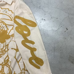 Off-white long-sleeve shirt with gold script-style print on sleeve