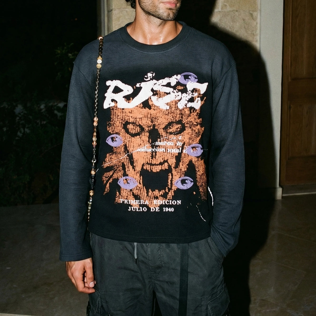 Black long-sleeve crewneck sweatshirt with bold orange front graphic