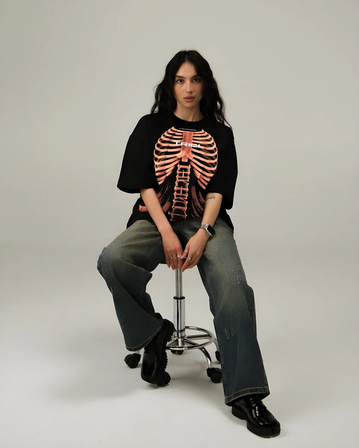Black graphic T-shirt with orange ribcage skeleton print, crew neck, short sleeves