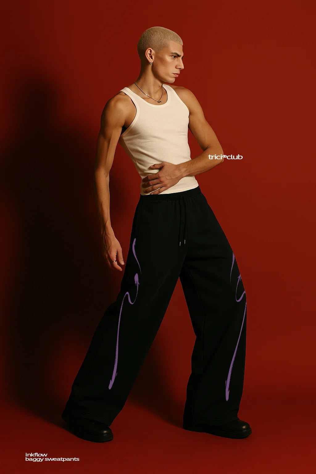 Black sweatpants with elastic waist and drawstring, purple ink drip graphic, full length