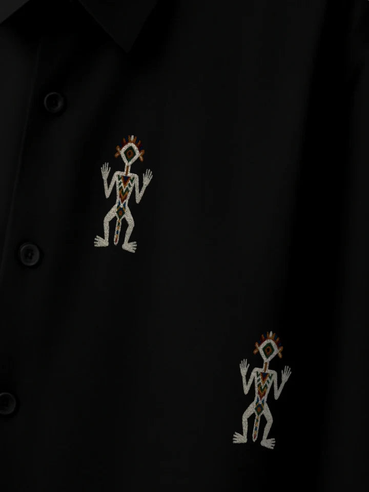 Black boxy fit button-up shirt with two embroidered figures near the buttons