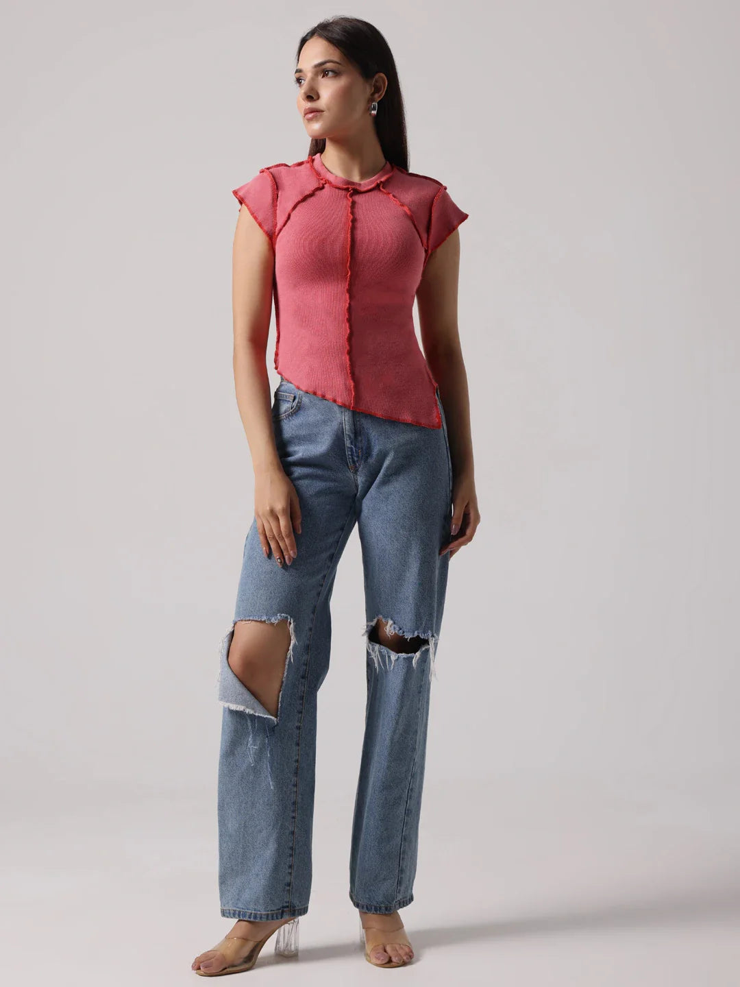 Rose-pink exposed-stitch top with short cap sleeves, round neckline, and side drape